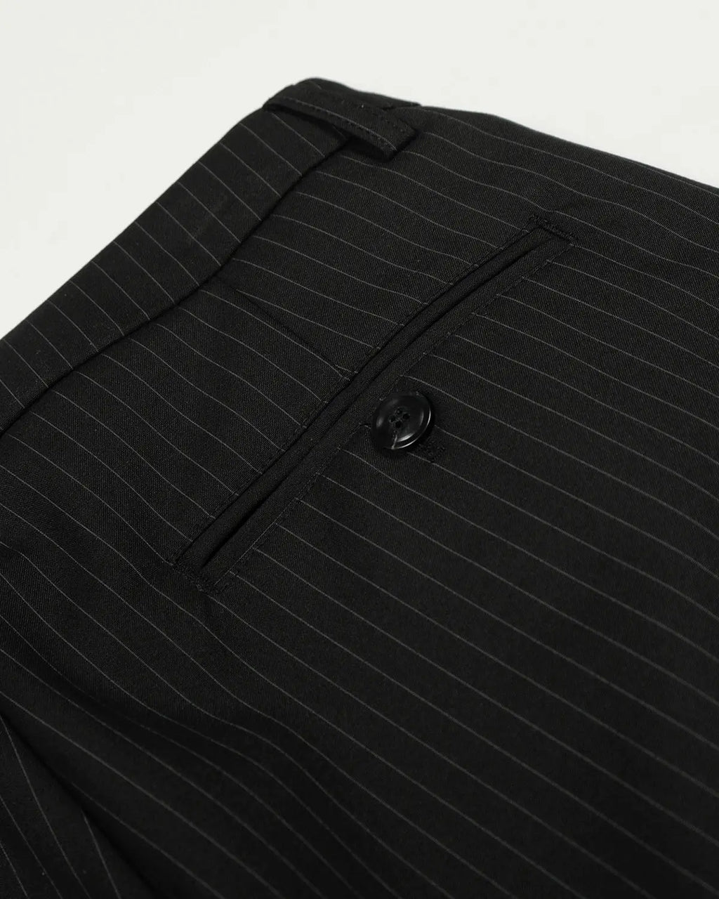 Black striped barrel pants by Flation Streetwear, featuring a relaxed fit and bold striped pattern, shown on a model.