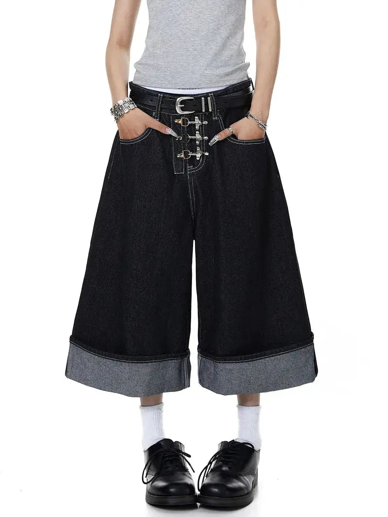 Black raw denim jorts with buckle detail from Flation Streetwear, featuring distressed edges and a casual, edgy style.