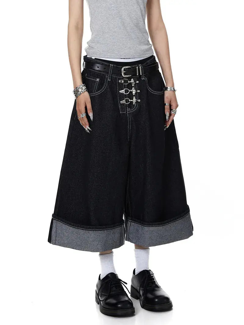 Black Flation raw denim jorts with buckle detail, styled as streetwear pants with a casual, edgy look.
