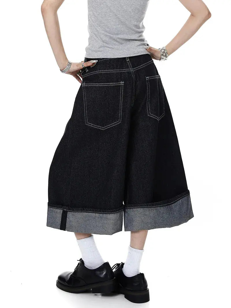 Black Flation streetwear raw denim jorts with buckle detail, casual pants featuring distressed design and raw hem.