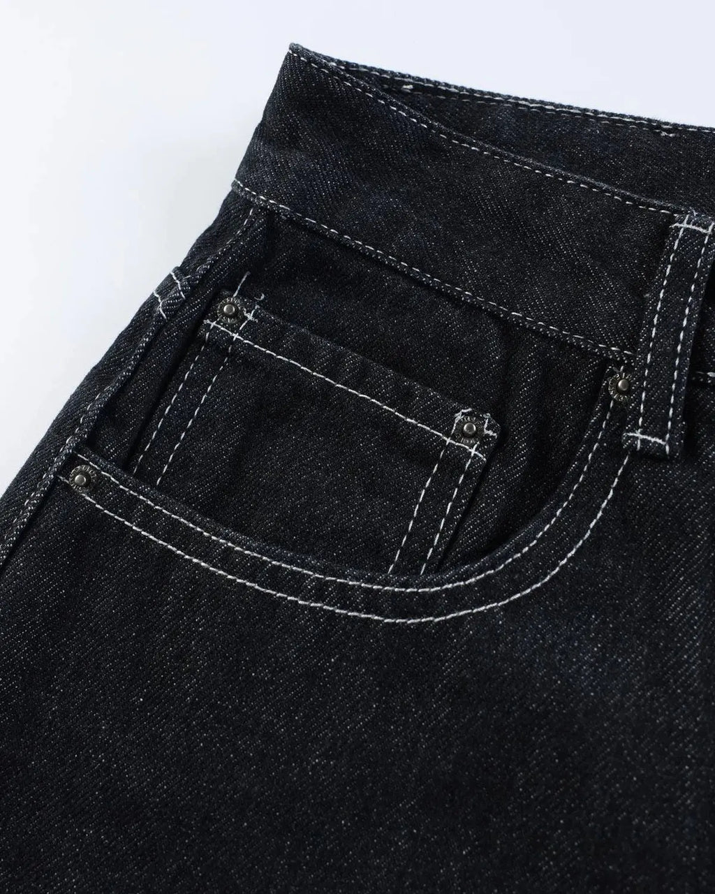 Black raw denim jorts with buckle detail by Flation Streetwear, showcasing distressed raw denim and stylish design.