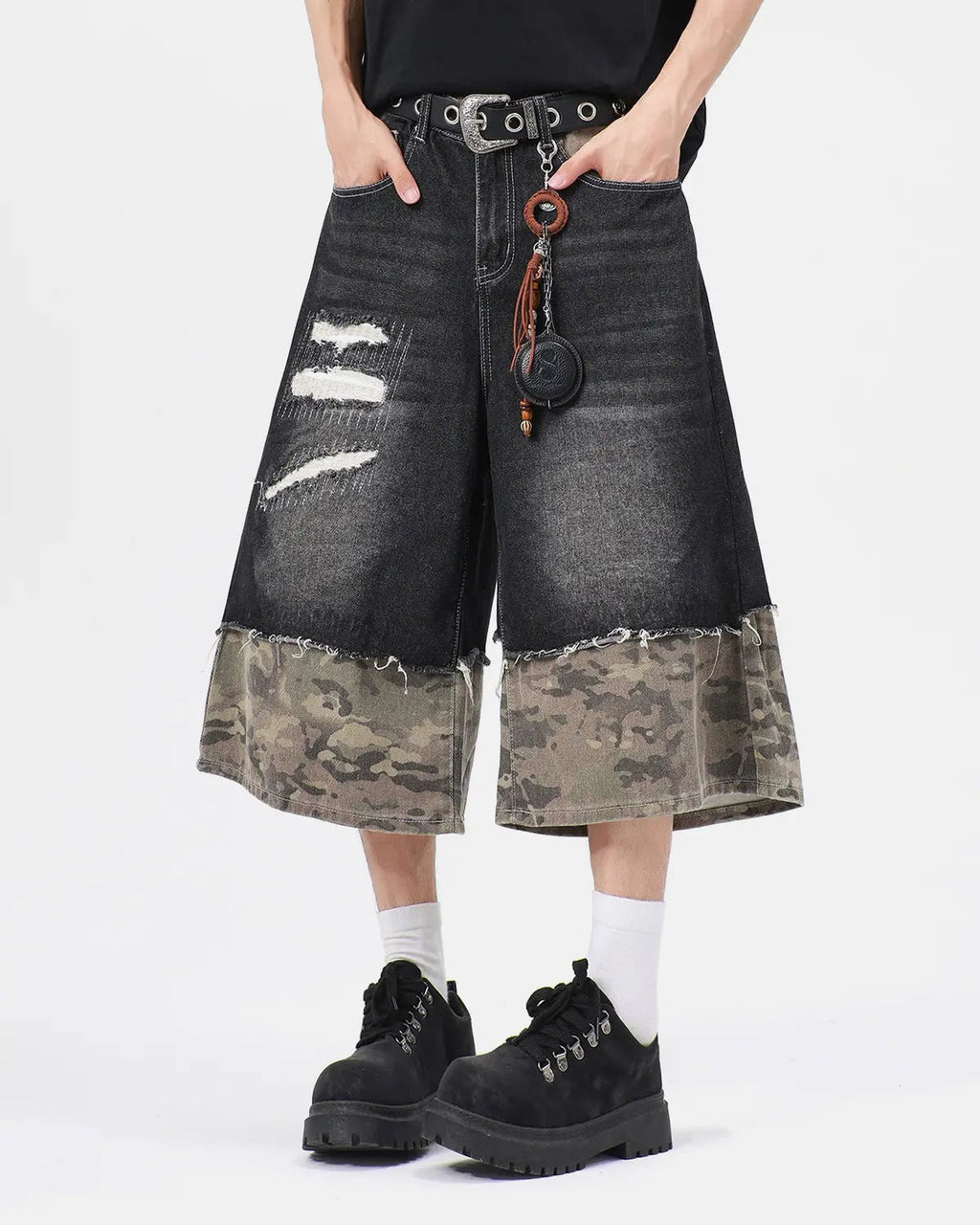 Black camo patchwork washed denim jorts by Flation, casual streetwear pants with distressed denim and patchwork design.