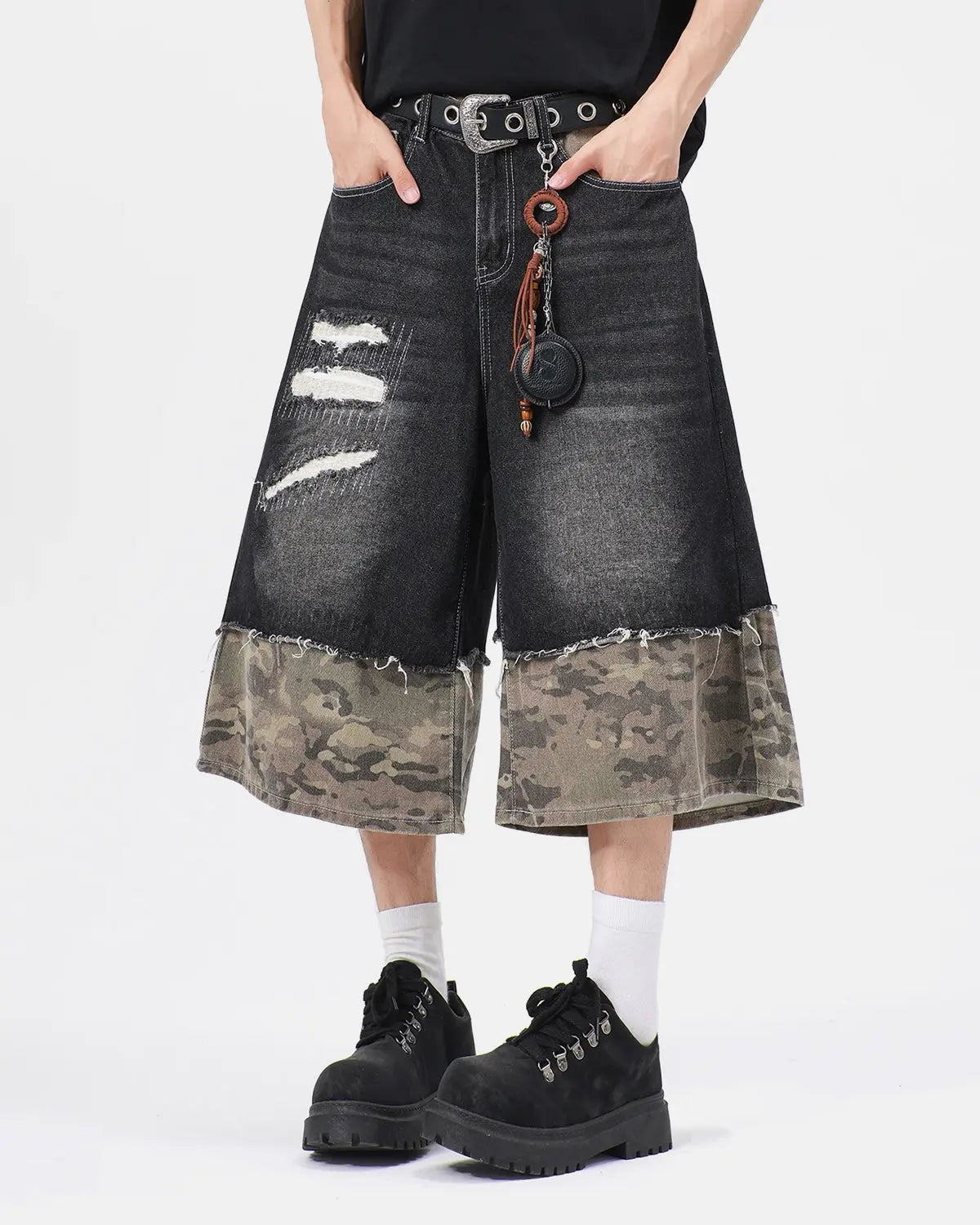 Black camo patchwork washed denim jorts by Flation, casual streetwear pants with distressed denim and patchwork design.