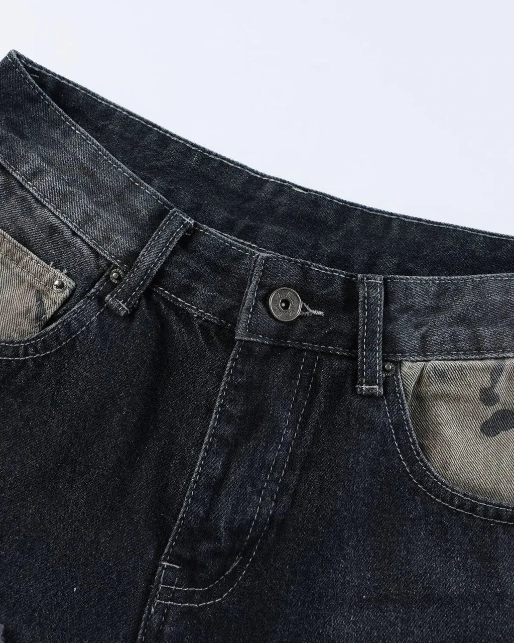 Black camo patchwork washed denim jorts by Flation, stylish streetwear pants with distressed denim and rugged patch details.
