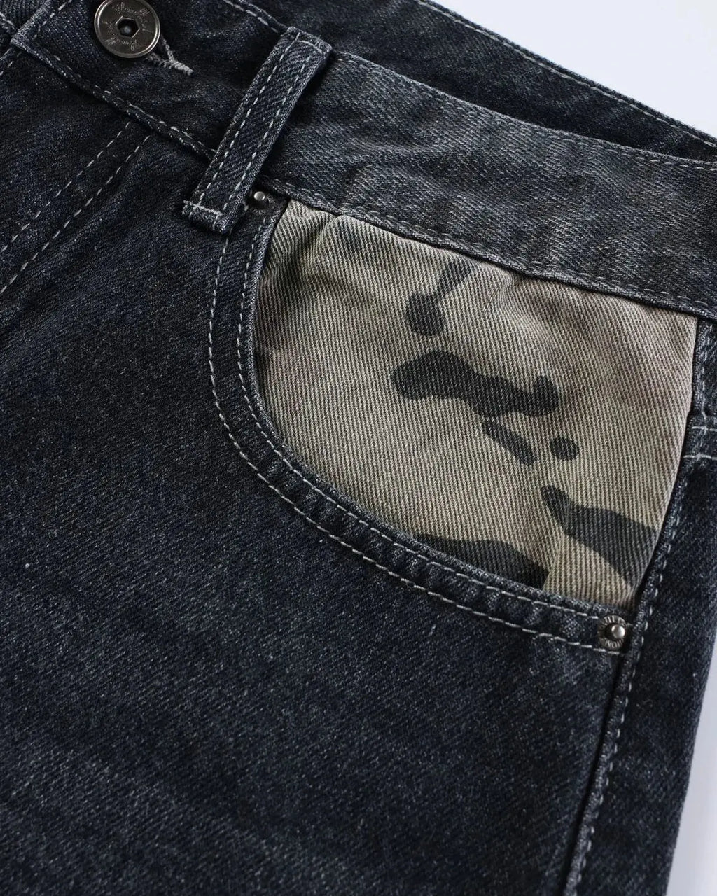 Black camo patchwork washed denim jorts by Flation, stylish streetwear pants with a rugged, casual look.