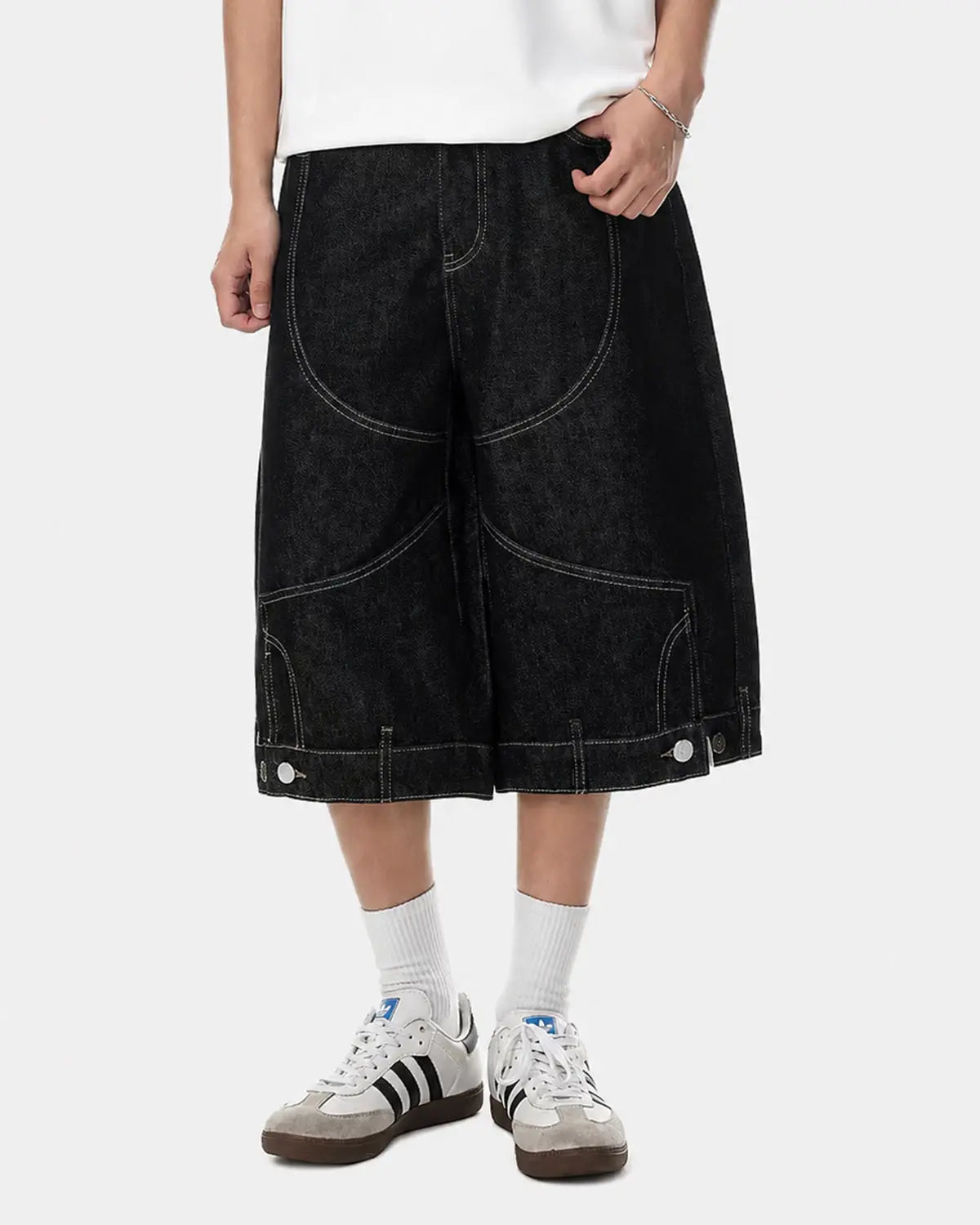 Black deconstructed raw denim jorts by Flation streetwear, casual pants with frayed edges and distressed details.