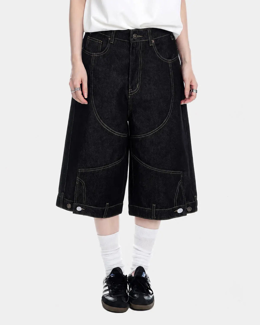 Black deconstructed raw denim jorts by Flation Streetwear, showing distressed details and casual fit on pants.