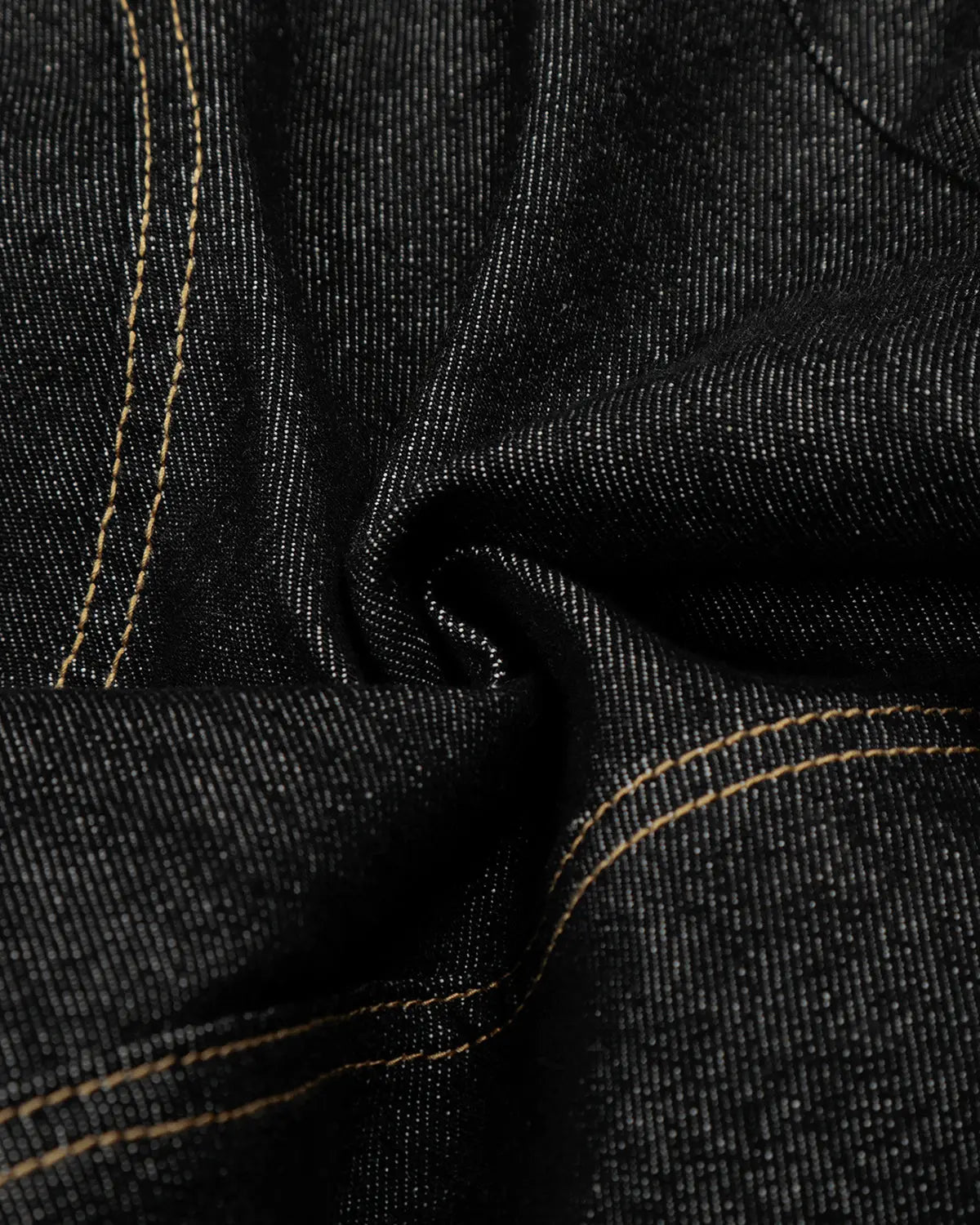 Black deconstructed raw denim jorts by Flation, casual streetwear pants with distressed detailing and frayed hems.