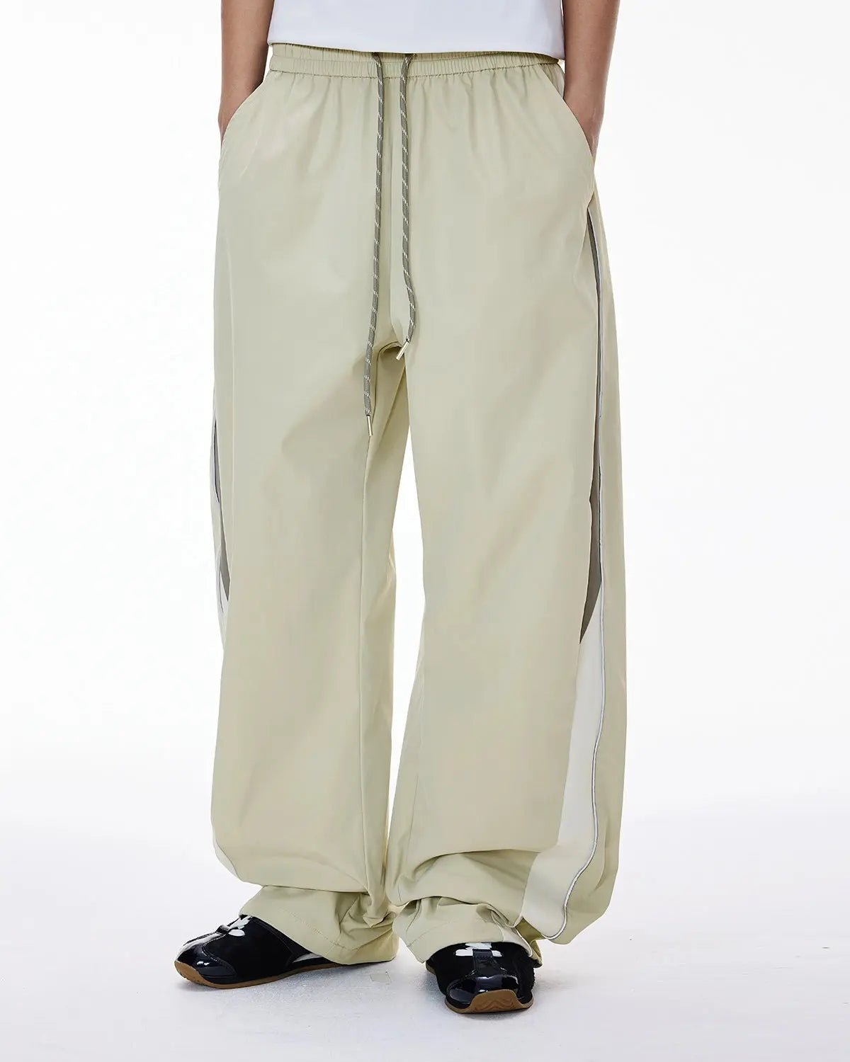 Black Flation reflective windbreaker track pants, stylish streetwear pants with reflective accents and a comfortable fit.