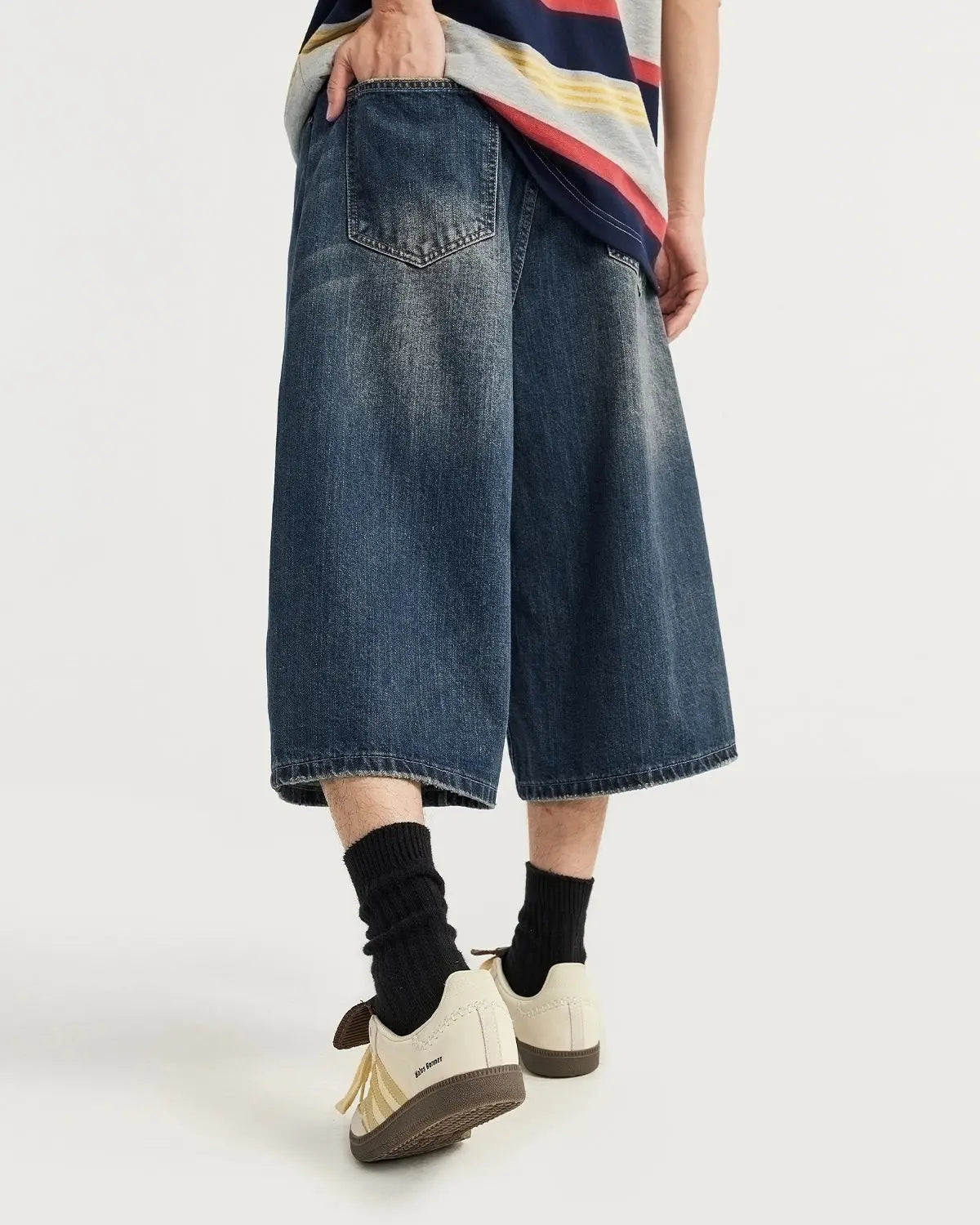 Acid washed longline baggy denim jorts by Flation Streetwear, featuring distressed details and relaxed fit, displayed on a hanger.