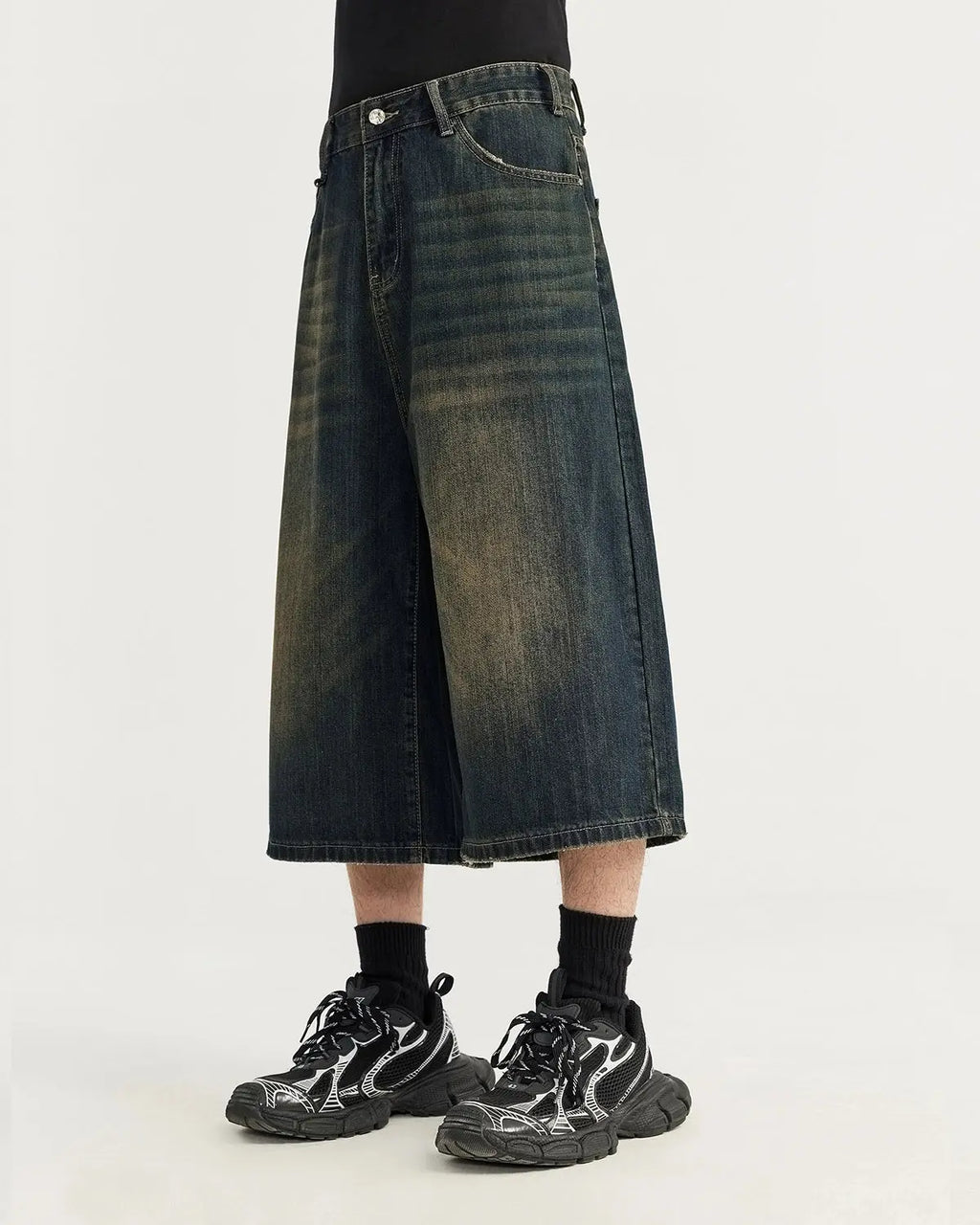 Acid washed longline baggy denim jorts by Flation, featuring a relaxed fit and distressed detailing, styled as streetwear pants.