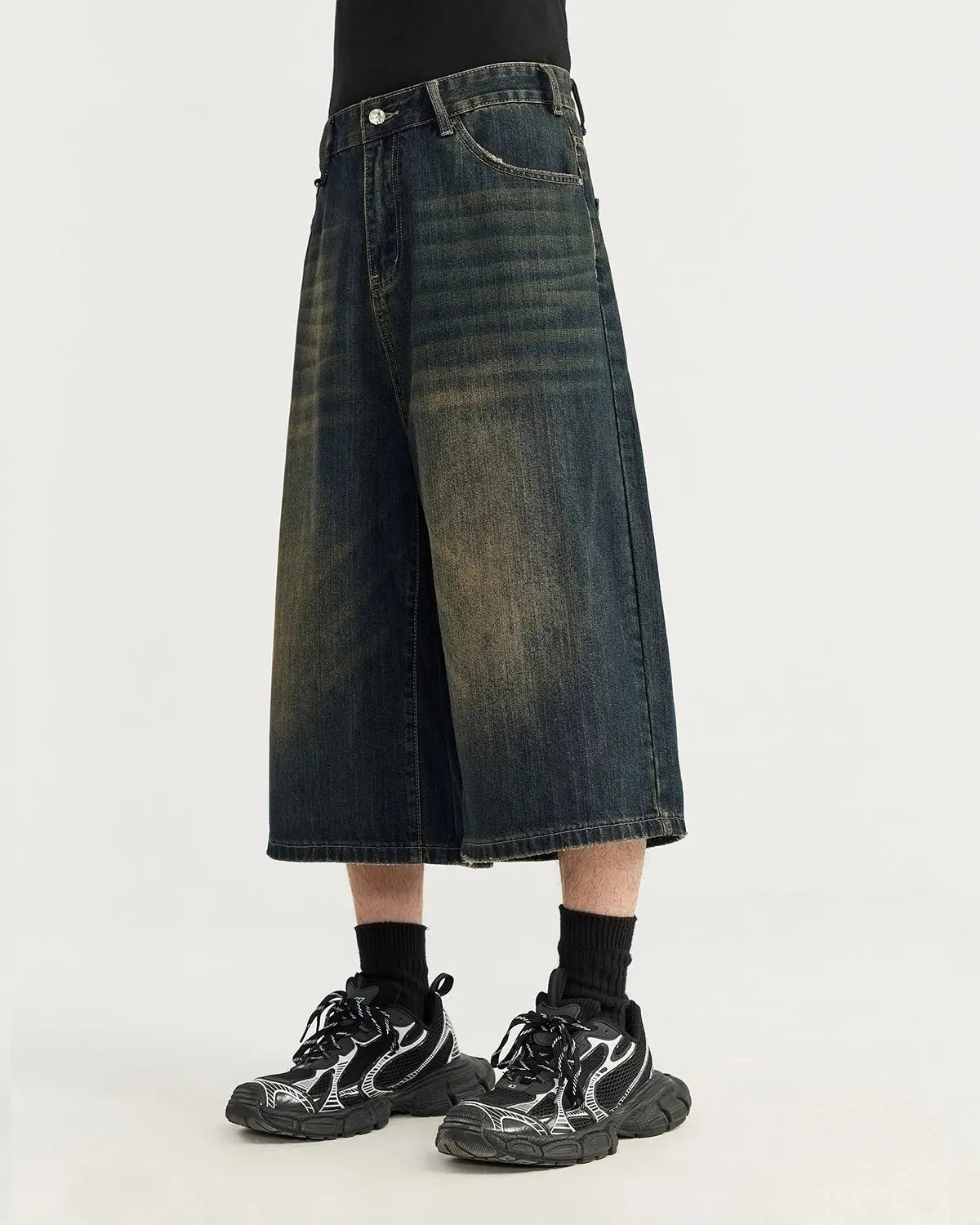 Acid washed longline baggy denim jorts by Flation, featuring a relaxed fit and distressed detailing, styled as streetwear pants.