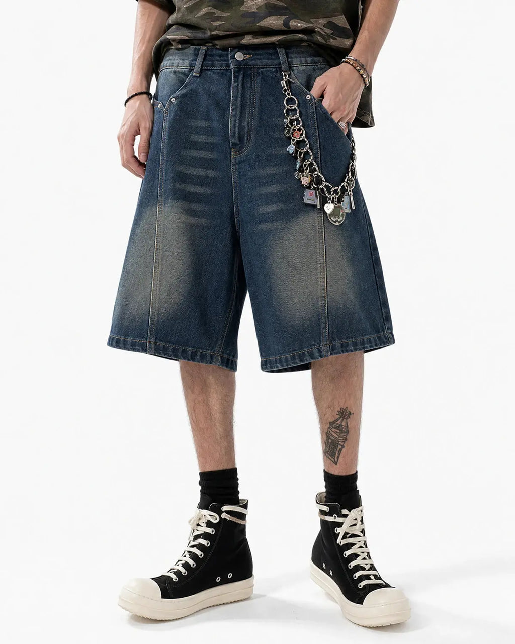 Blue deconstructed washed denim Jorts pants by Flation, featuring distressed details and a relaxed streetwear style.