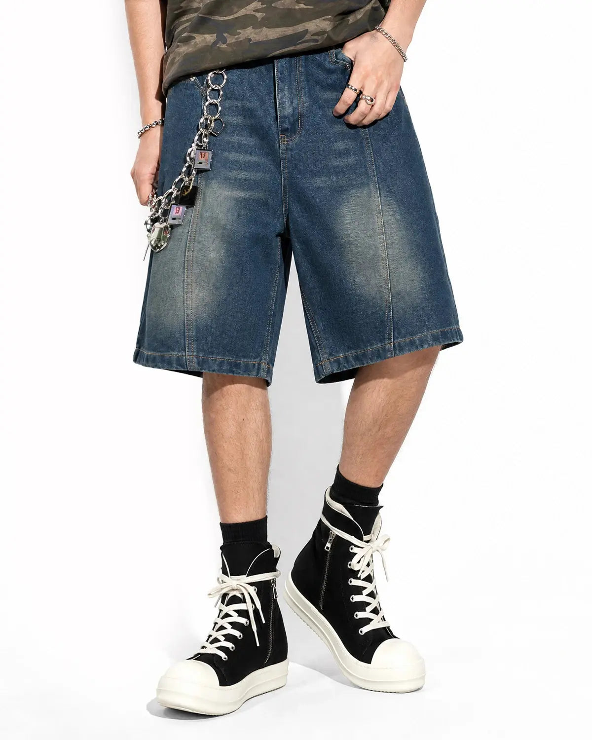 Blue deconstructed washed denim jorts by Flation, casual streetwear pants with frayed hems and relaxed fit.