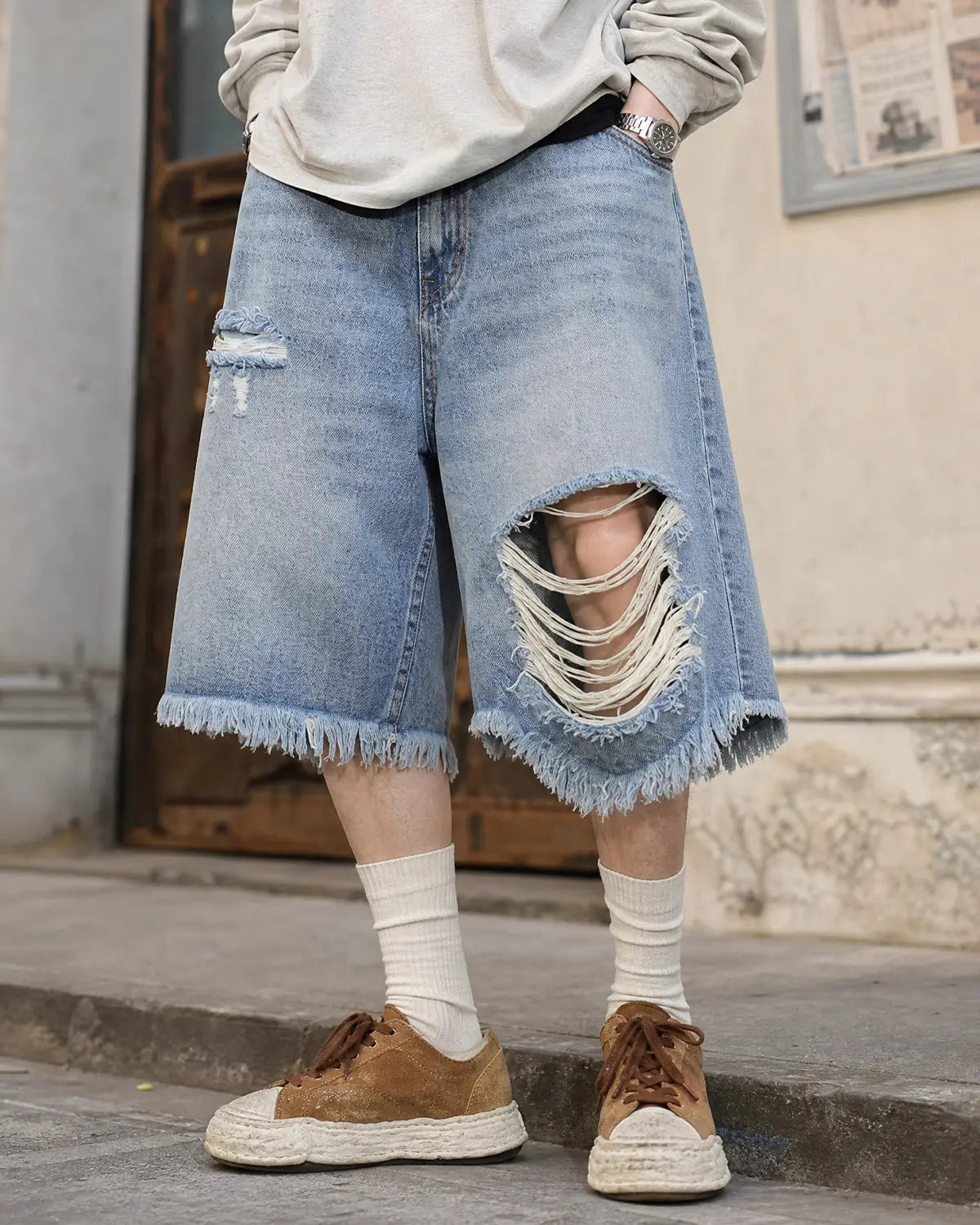 Blue distressed baggy jorts from Flation Streetwear with adjustable waist tabs, casual denim pants for a relaxed street style look.