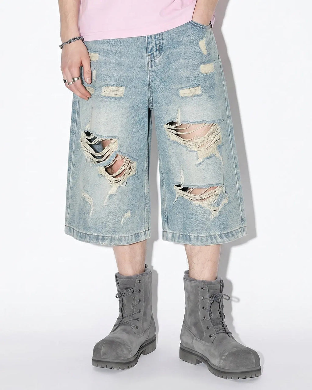 Blue distressed longline jorts pants by Flation Streetwear featuring a relaxed fit and frayed edges.