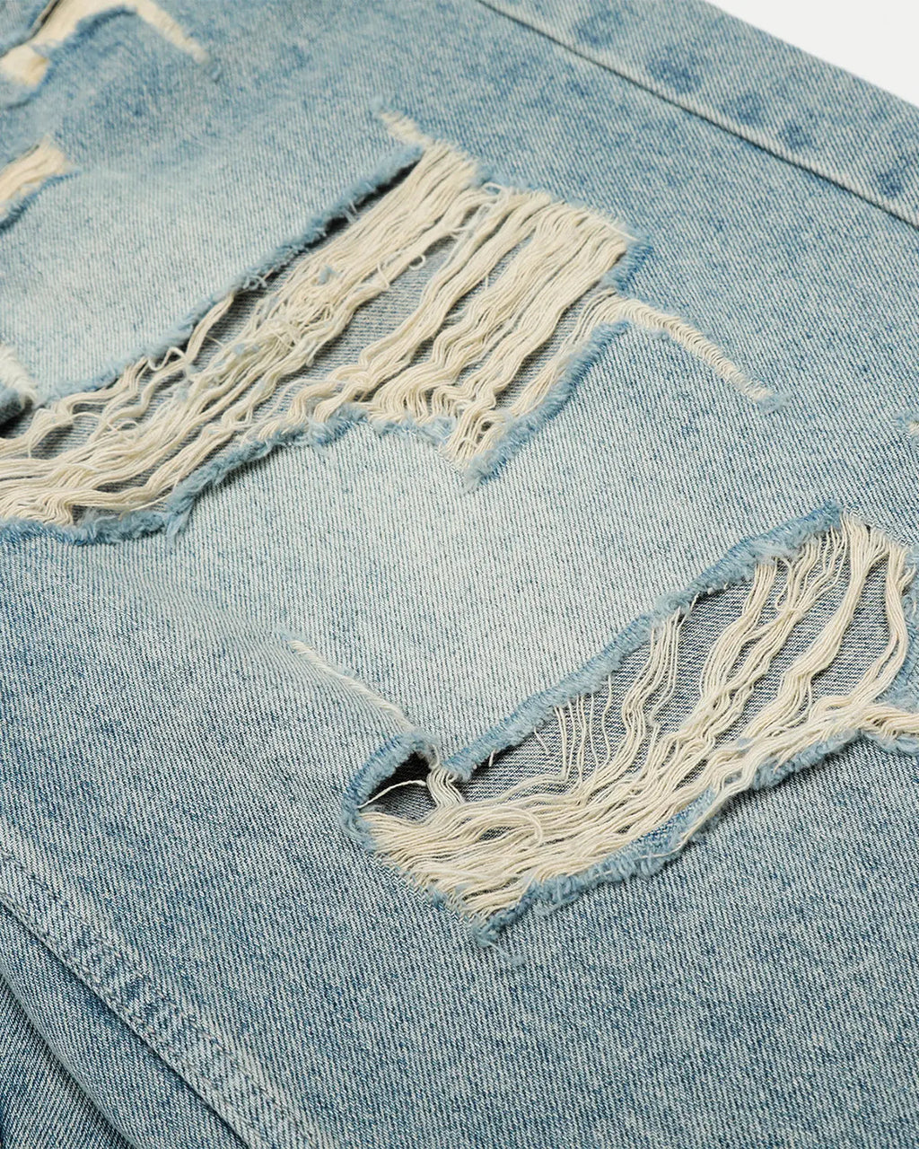 Blue distressed longline jorts by Flation Streetwear, featuring a relaxed fit and casual streetwear style.
