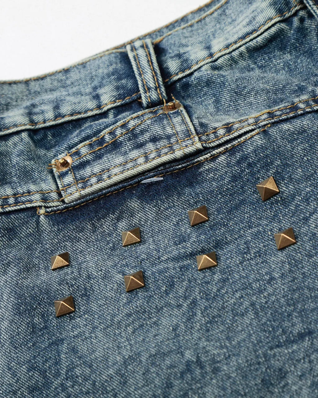 Blue studded washed long baggy jorts by Flation Streetwear, relaxed fit denim pants with metal studs and distressed details.