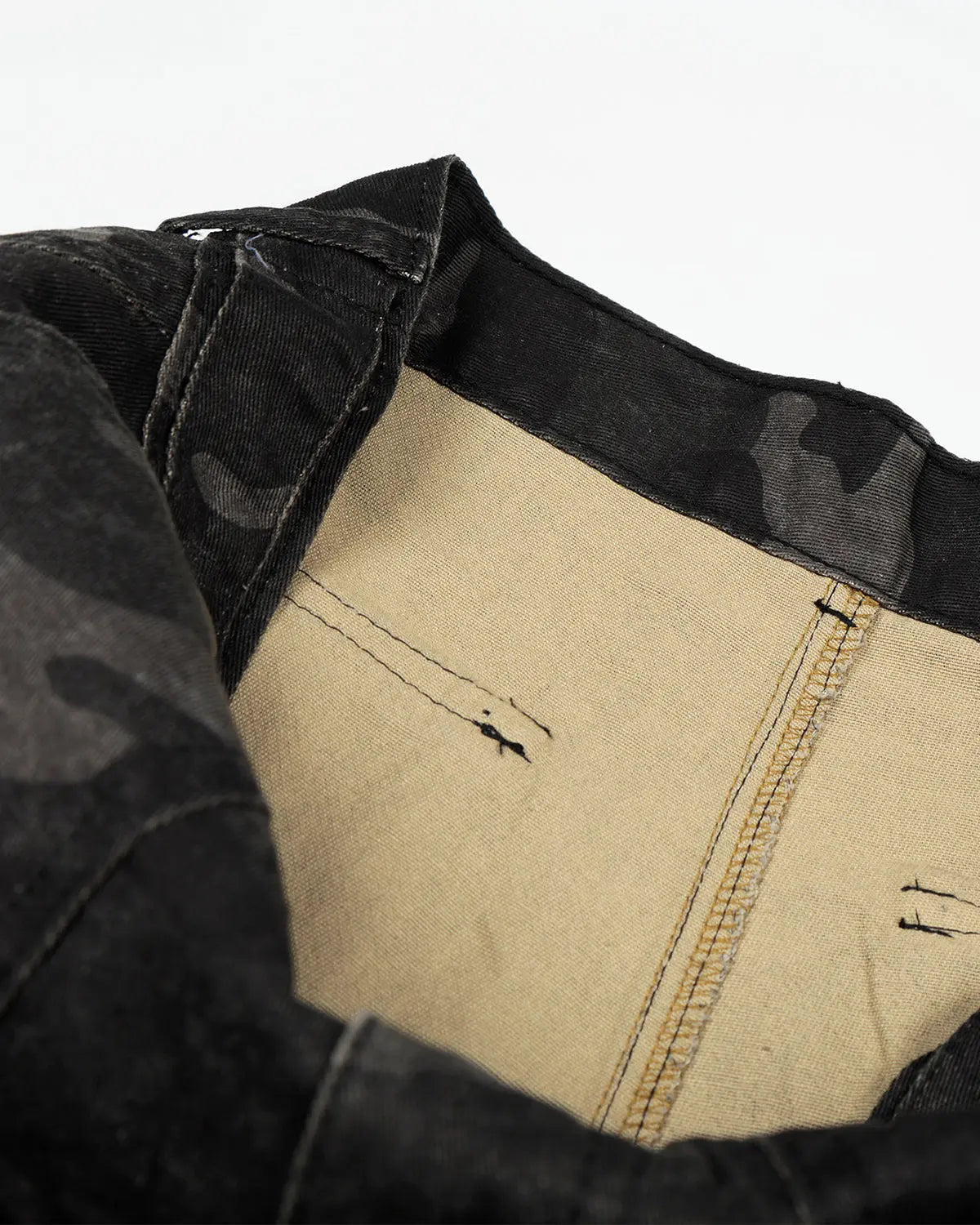 Dark camouflage cargo shorts by Flation Streetwear, featuring multiple pockets and a relaxed fit, shown on a model.