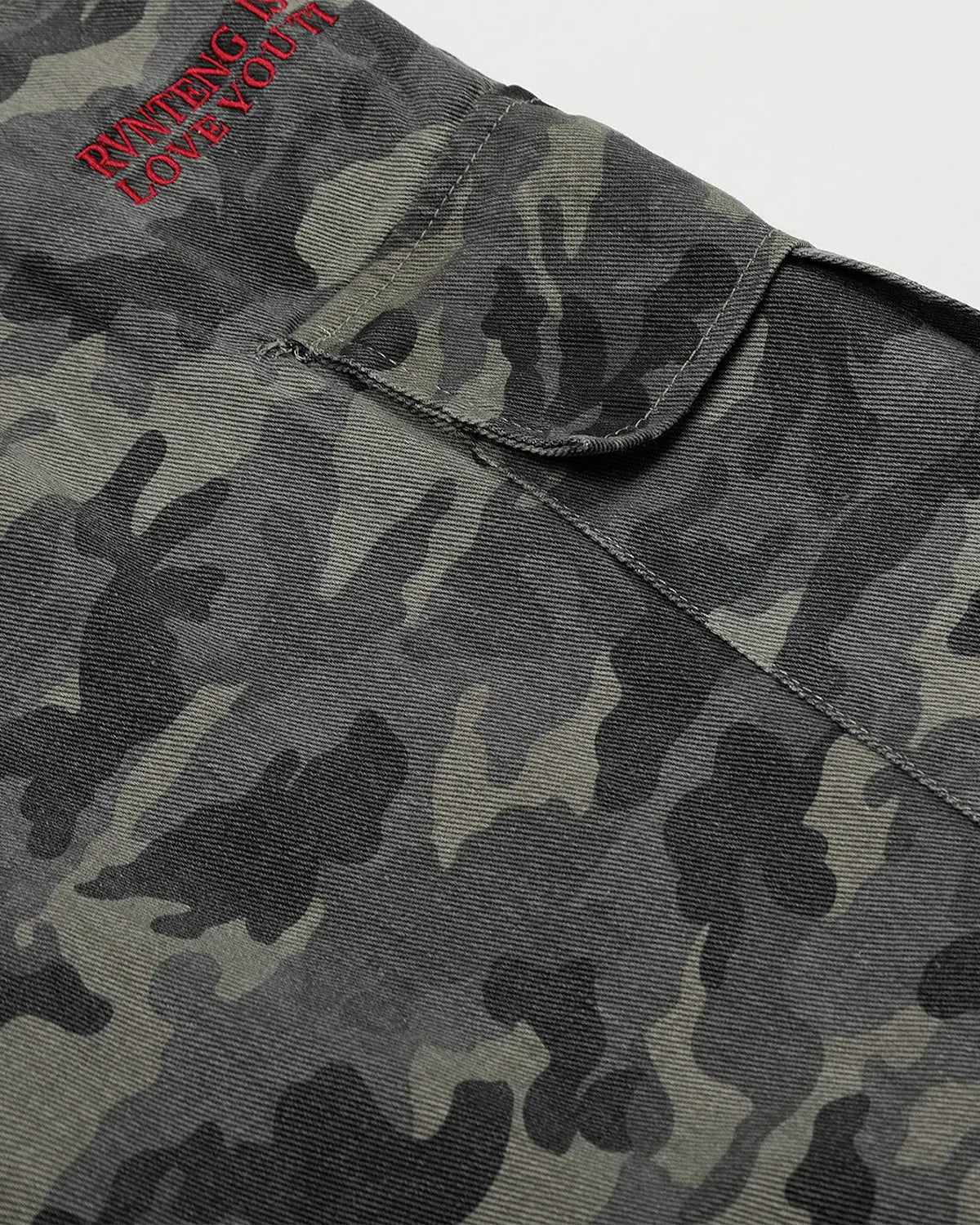 Embroidered camo cargo shorts by Flation Streetwear, featuring rugged camouflage fabric and detailed embroidery on the pants.