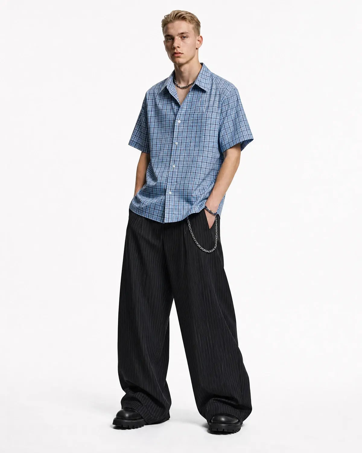 Flation pinstripe pleated barrel pants with tailored fit, featuring a high waist and stylish pleats, suitable for streetwear fashion.