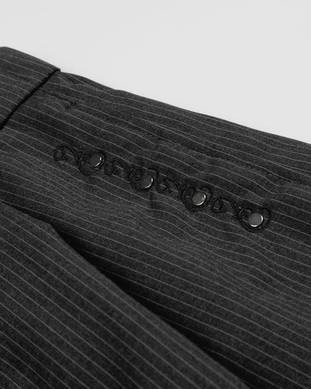 Flation pinstripe stud detail tailored shorts, stylish streetwear pants with pinstripes and metal stud accents on front.