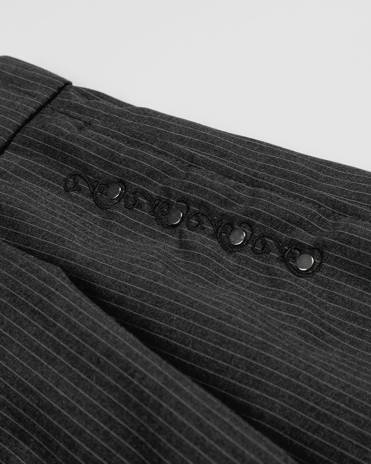 Flation pinstripe stud detail tailored shorts, stylish streetwear pants with pinstripes and metal stud accents on front.