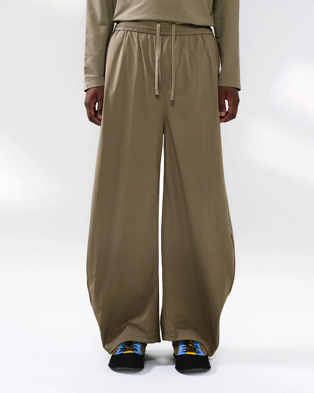 Flation outdoor quick dry track pants displayed on a model, featuring a sleek design suitable for active streetwear and sports activities.