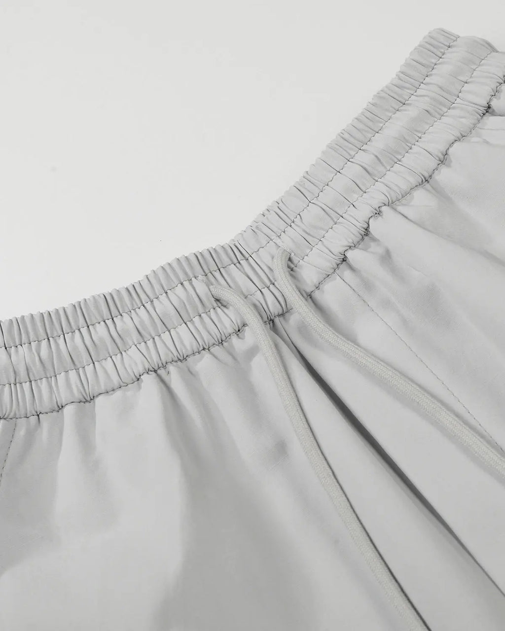 Grey Flation streetwear contrast panel baggy track pants with relaxed fit and adjustable waistband, styled for casual wear.