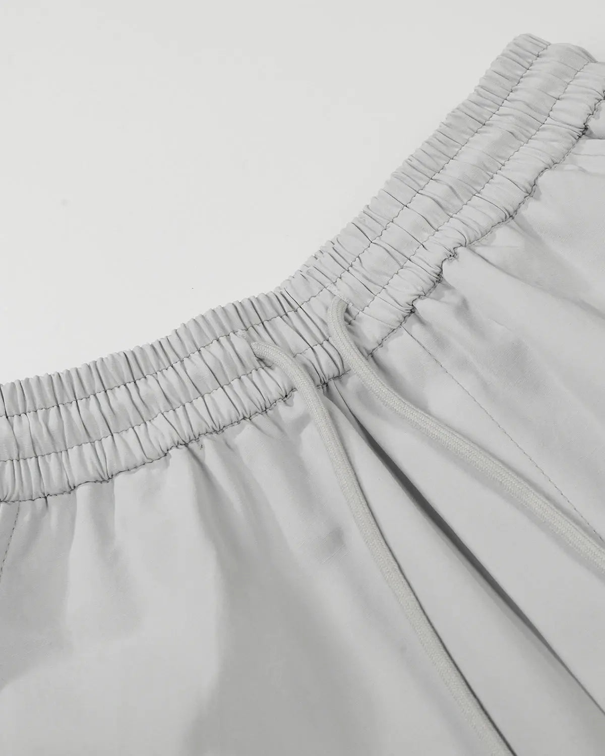 Grey Flation streetwear contrast panel baggy track pants with relaxed fit and adjustable waistband, styled for casual wear.