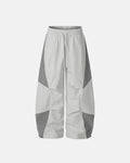 Gray Flation streetwear contrast panel baggy track pants with relaxed fit and stylish design, suitable for casual and athletic wear.