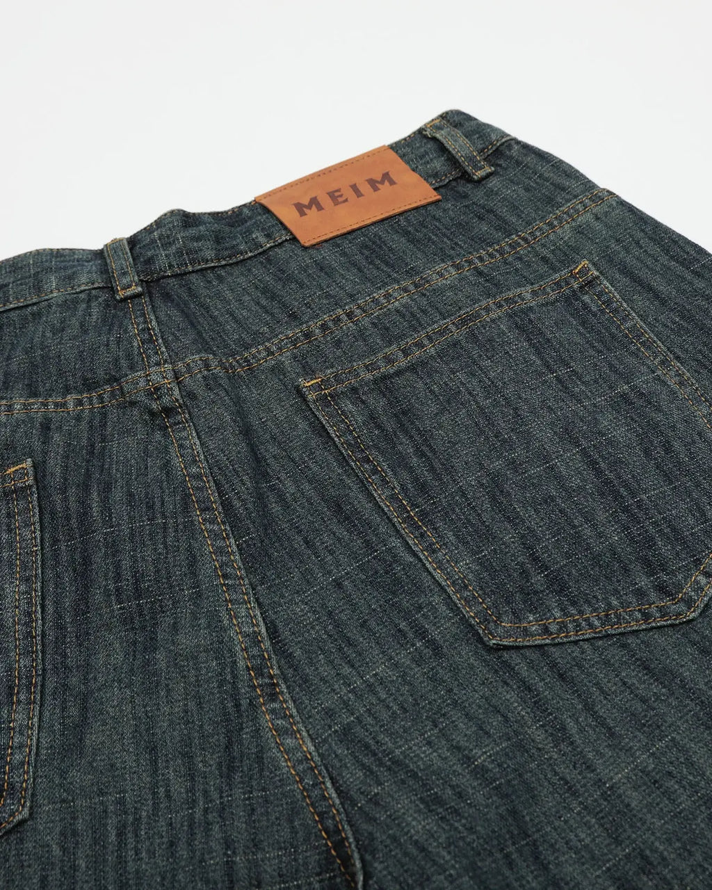 Raw wide-leg long jorts by Flation Streetwear, featuring distressed denim and a relaxed fit, displayed on a hanger.