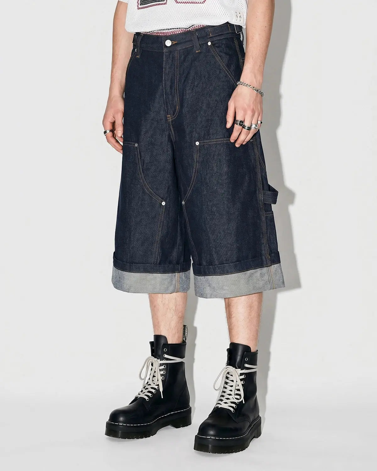 Raw denim carpenter long jorts by Flation Streetwear, showing rugged denim fabric and classic workwear pocket details.
