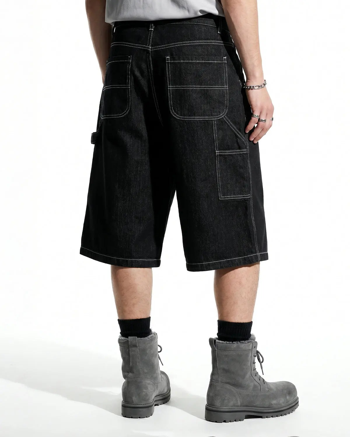 Contrast stitching raw cargo jorts by Flation; distressed denim pants with rugged style and visible stitching details.