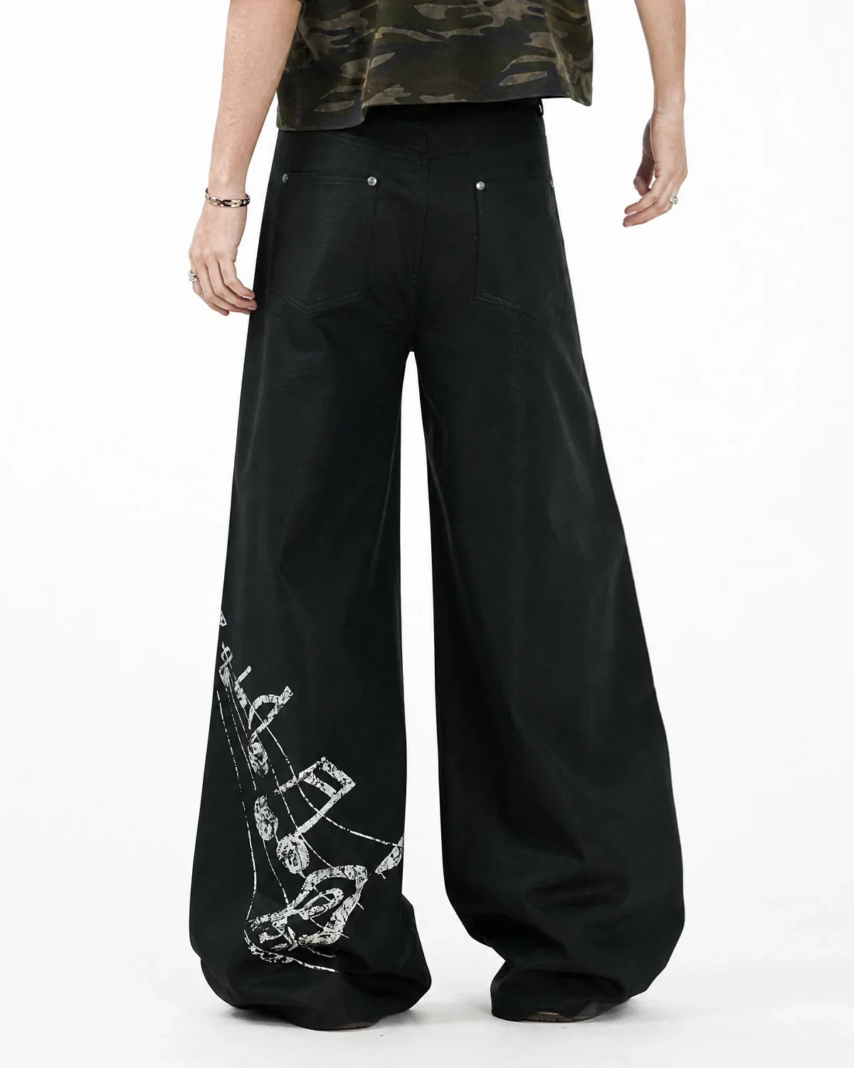 Black graphic wide leg pants from Flation Streetwear with bold design, loose fit, and stylish wide silhouette.
