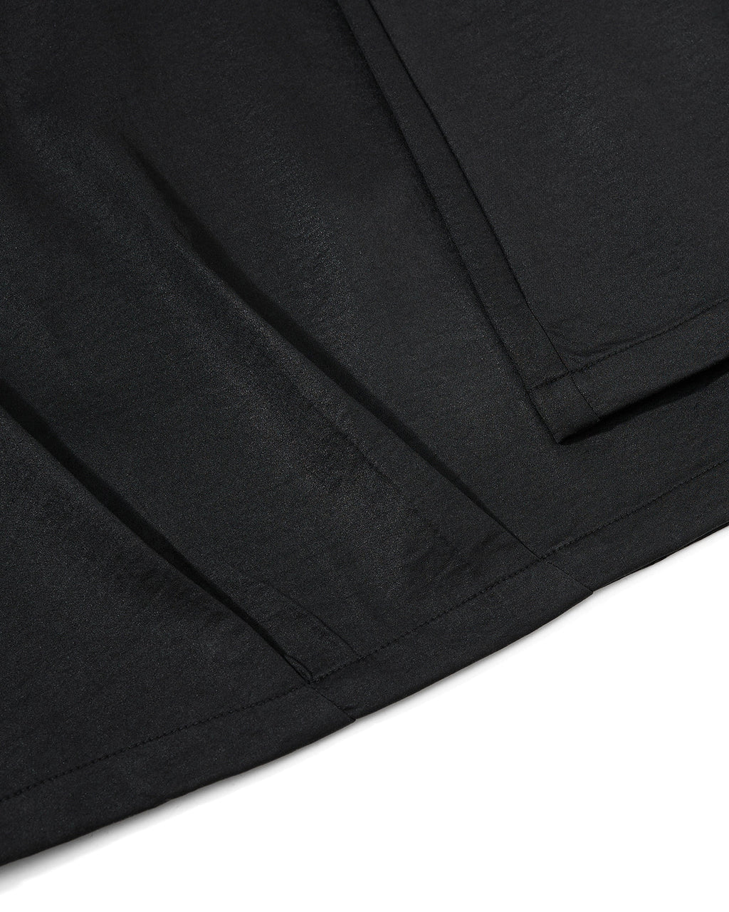 Black graphic wide leg pants by Flation featuring bold print, relaxed fit, and streetwear style, shown on a model.