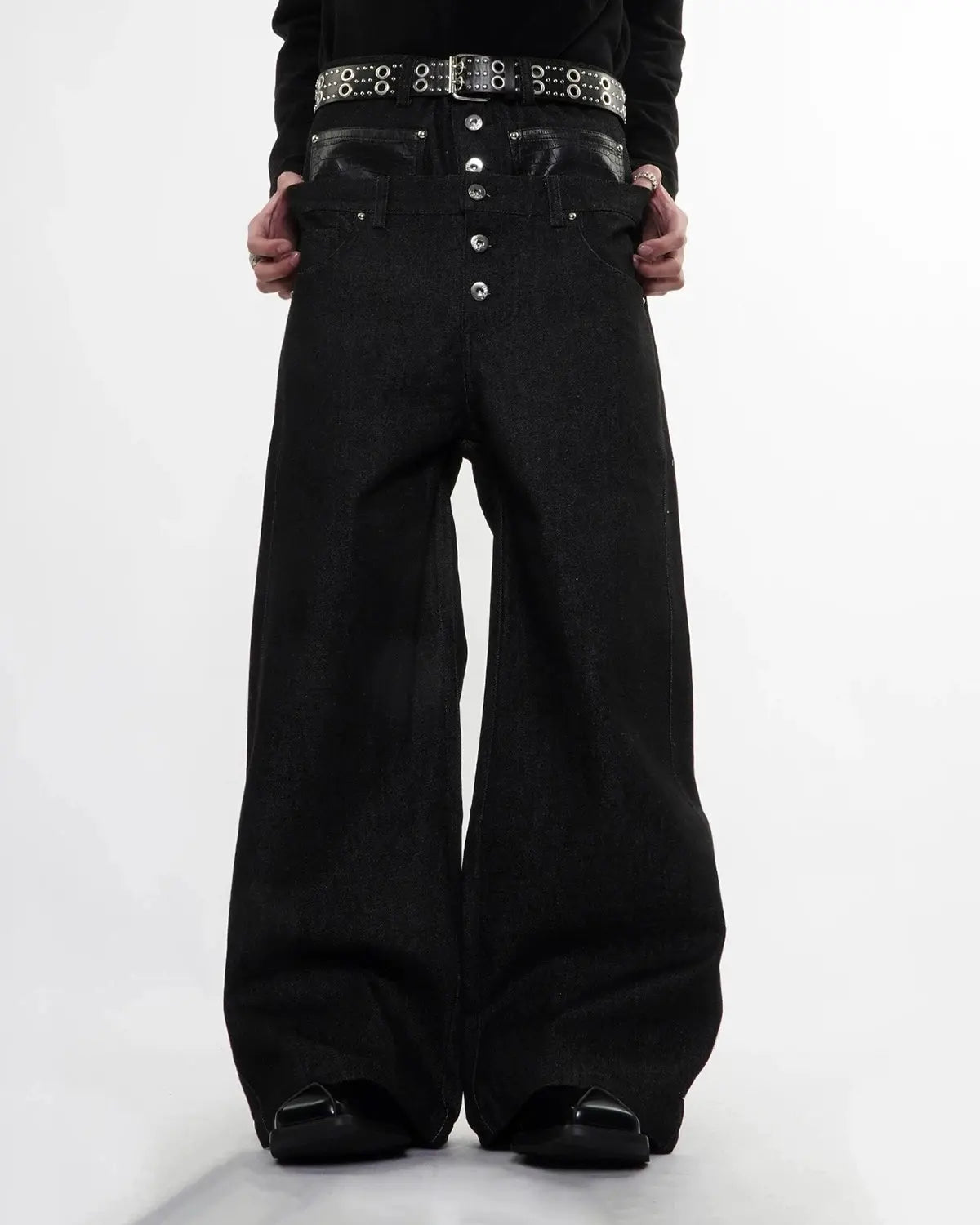 Black Flation streetwear double-wasit raw super baggy jeans with a relaxed fit and distressed details, styled on a model.