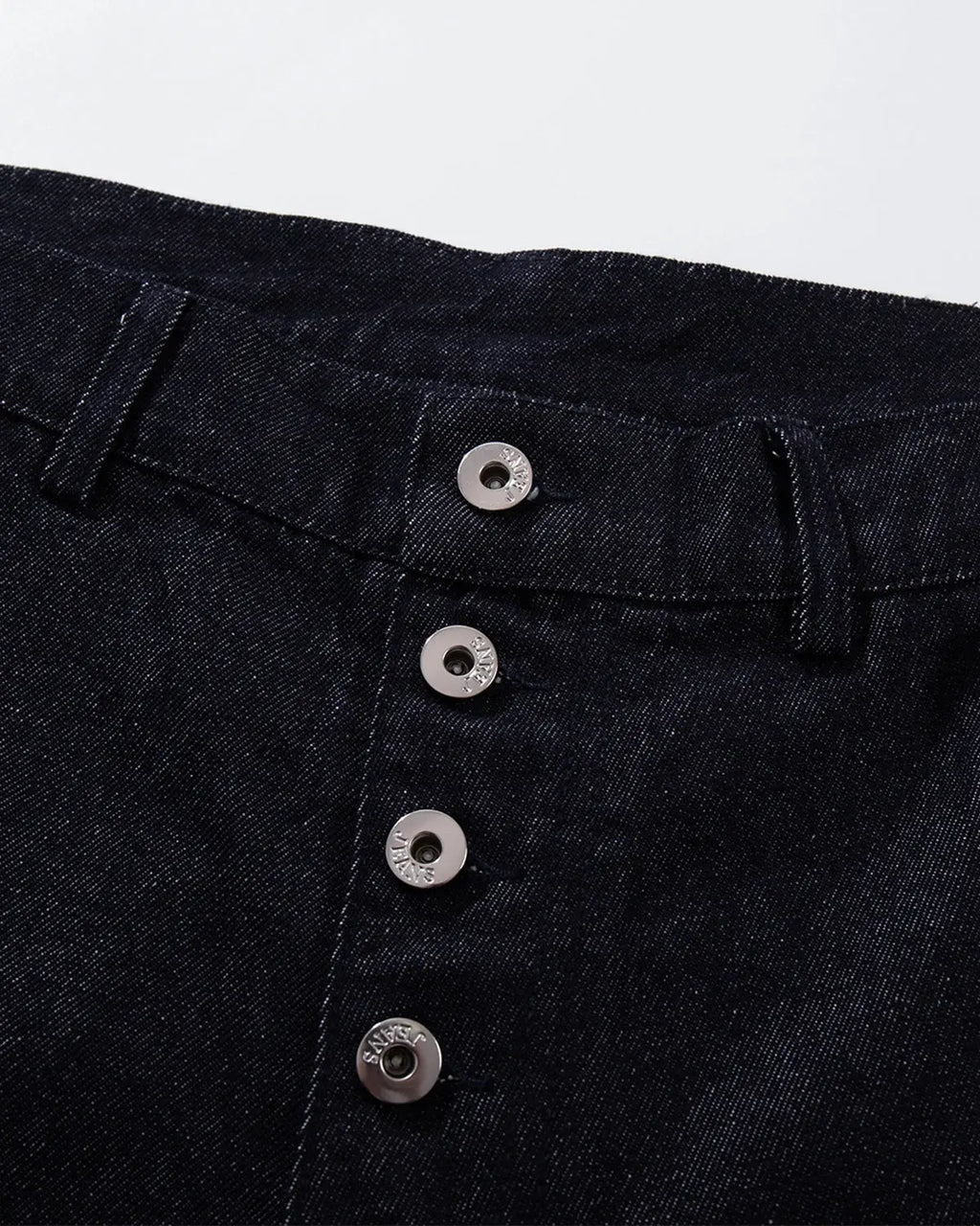 Raw blue baggy jeans from Flation Streetwear with button-up front and relaxed fit, shown on a model.
