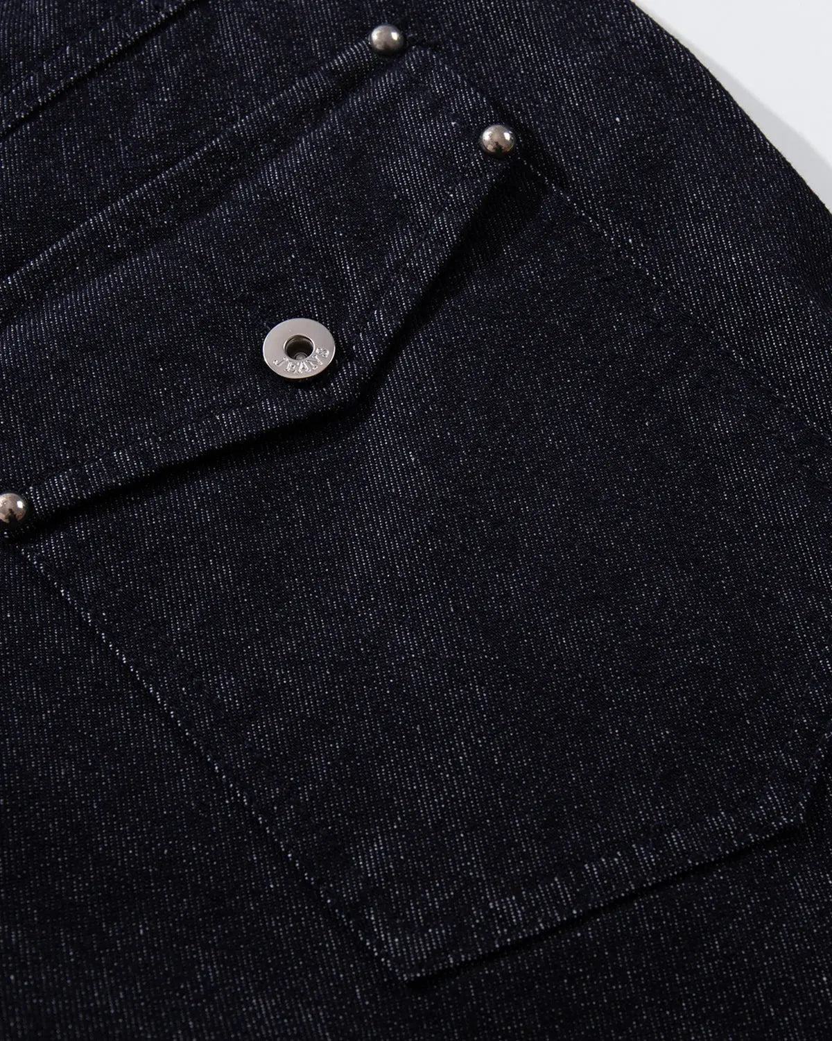 Raw blue baggy jeans by Flation, featuring button-up front and streetwear style, shown on a model.
