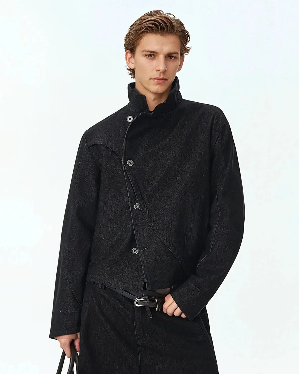Flation Cropped Asymmetric Button Denim Jacket featuring raw hem and streetwear style, worn by a model in an urban setting