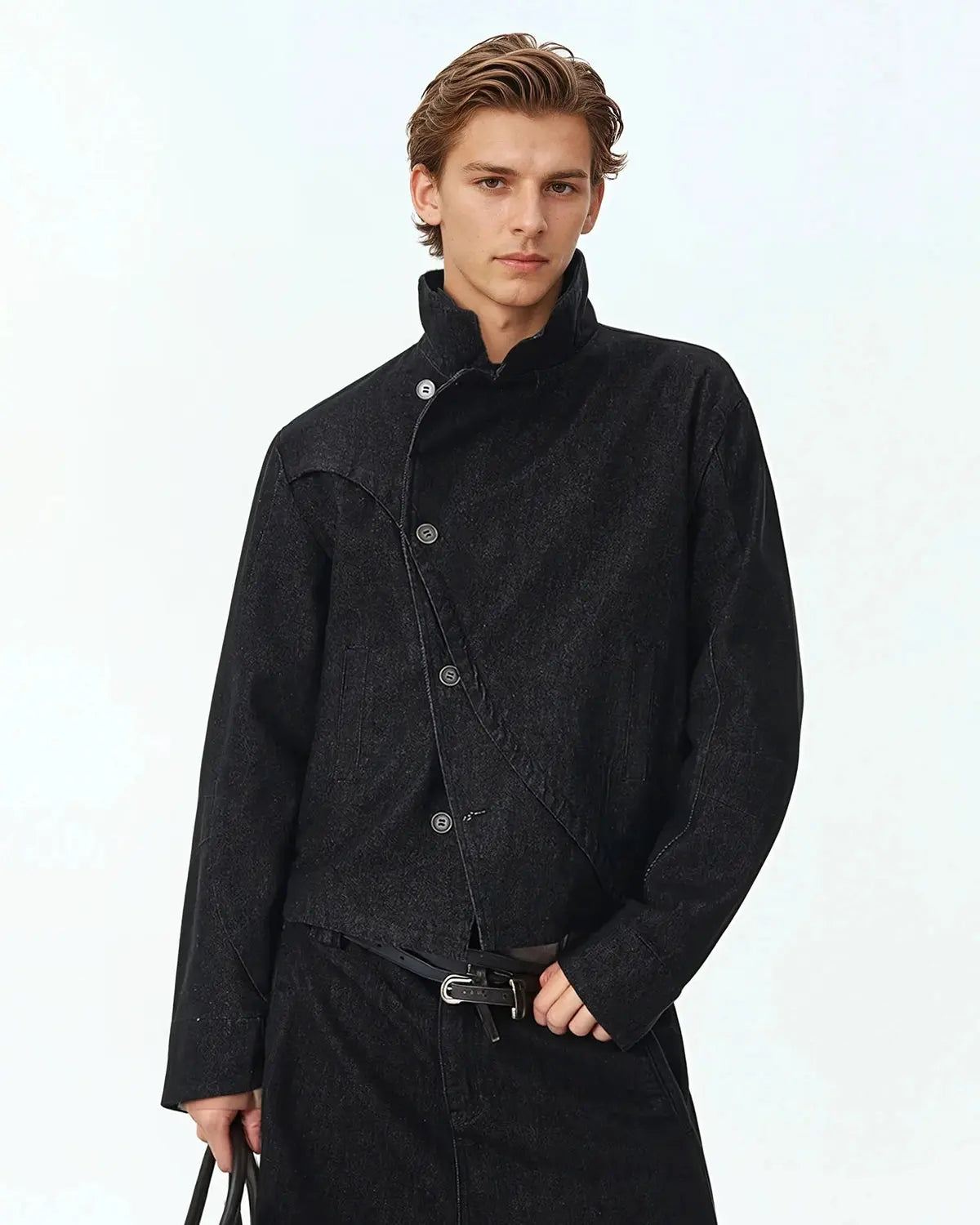 Flation Cropped Asymmetric Button Denim Jacket featuring raw hem and streetwear style, worn by a model in an urban setting