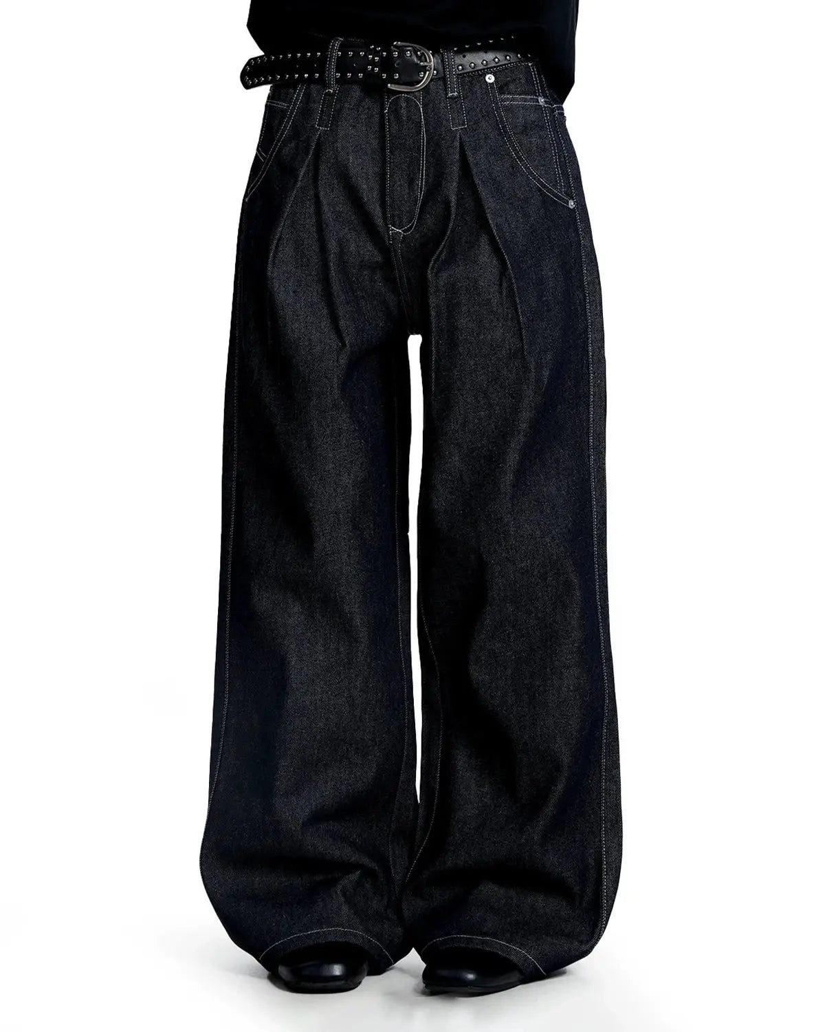 Raw baggy jeans with contrast stitching by Flation Streetwear, showing relaxed fit and detailed stitching on denim fabric.