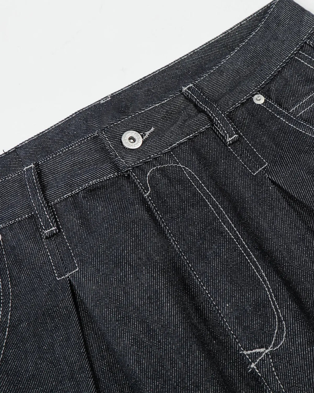Raw baggy jeans with contrast stitching by Flation Streetwear, showcasing distressed denim and relaxed fit style.