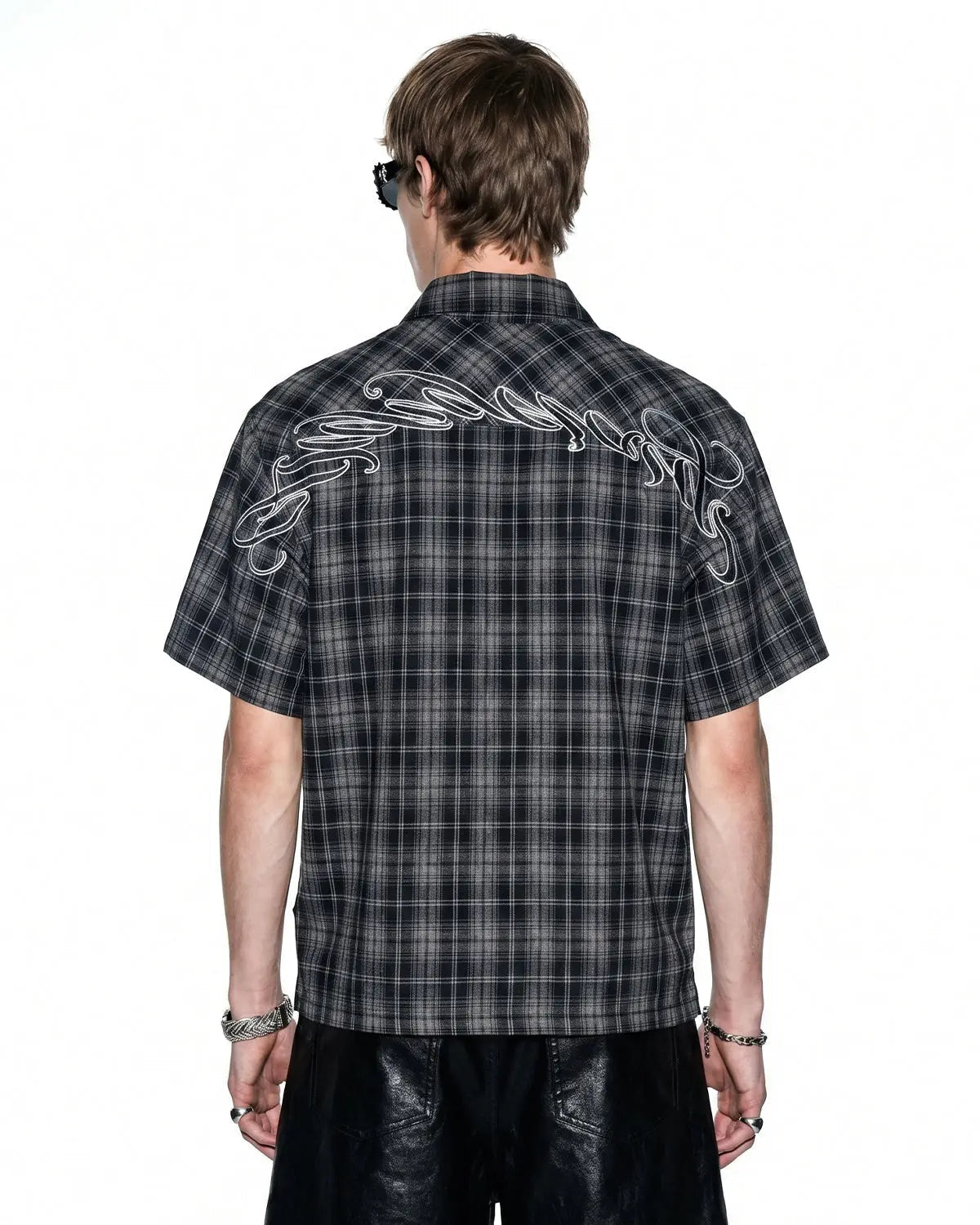Flation plaid script embroidered shirt featuring a stylish checkered pattern and embroidered lettering on the front.