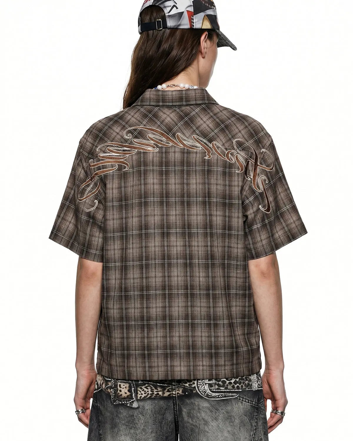 Flation plaid script embroidered shirt with long sleeves and button-front, featuring a stylish plaid pattern and embroidered design.