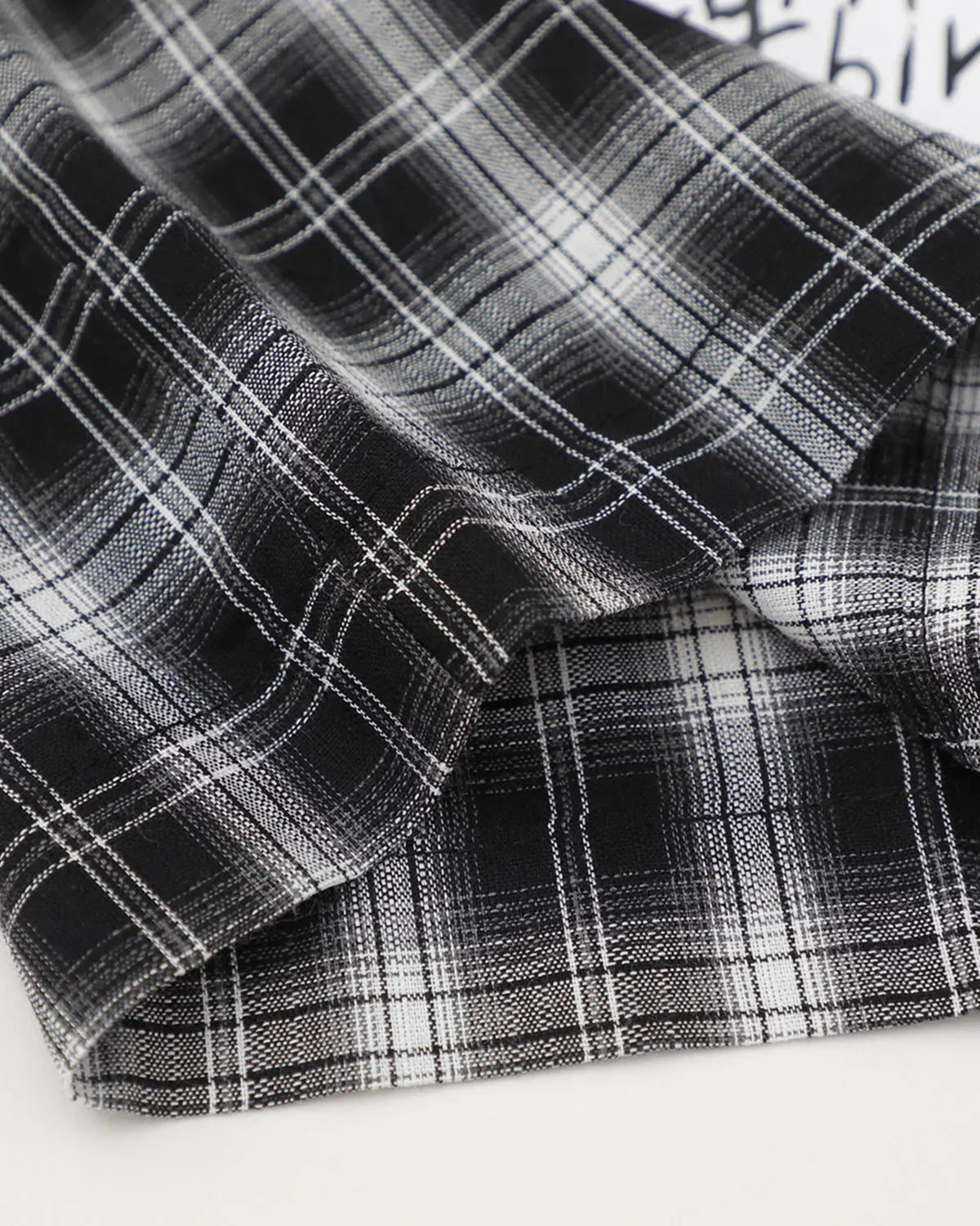 Flation plaid sticker graphic studded shirt featuring a classic plaid pattern, graphic design, and studded details on the streetwear shirt.