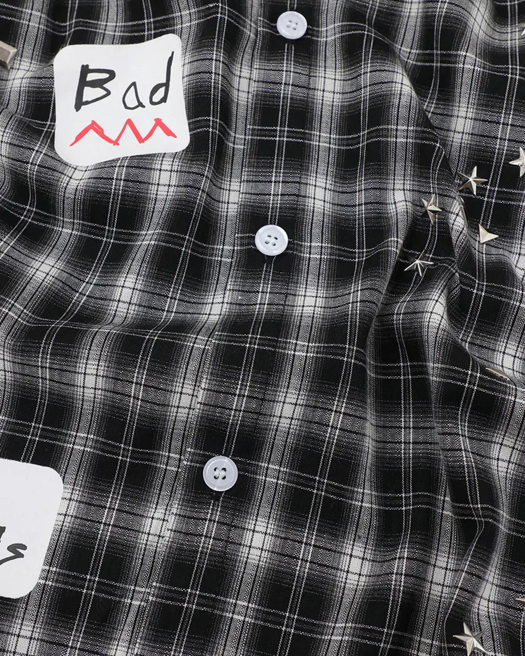 Flation plaid sticker graphic studded shirt featuring a checkered pattern, casual streetwear style, with studded accents.