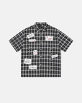 Flation plaid sticker graphic studded shirt featuring a checkered pattern, casual streetwear style, with studded details and bold design.
