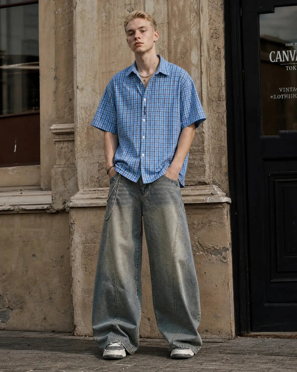 Flation plaid script embroidered short-sleeve shirt with a casual streetwear style, featuring a plaid pattern and embroidered lettering.