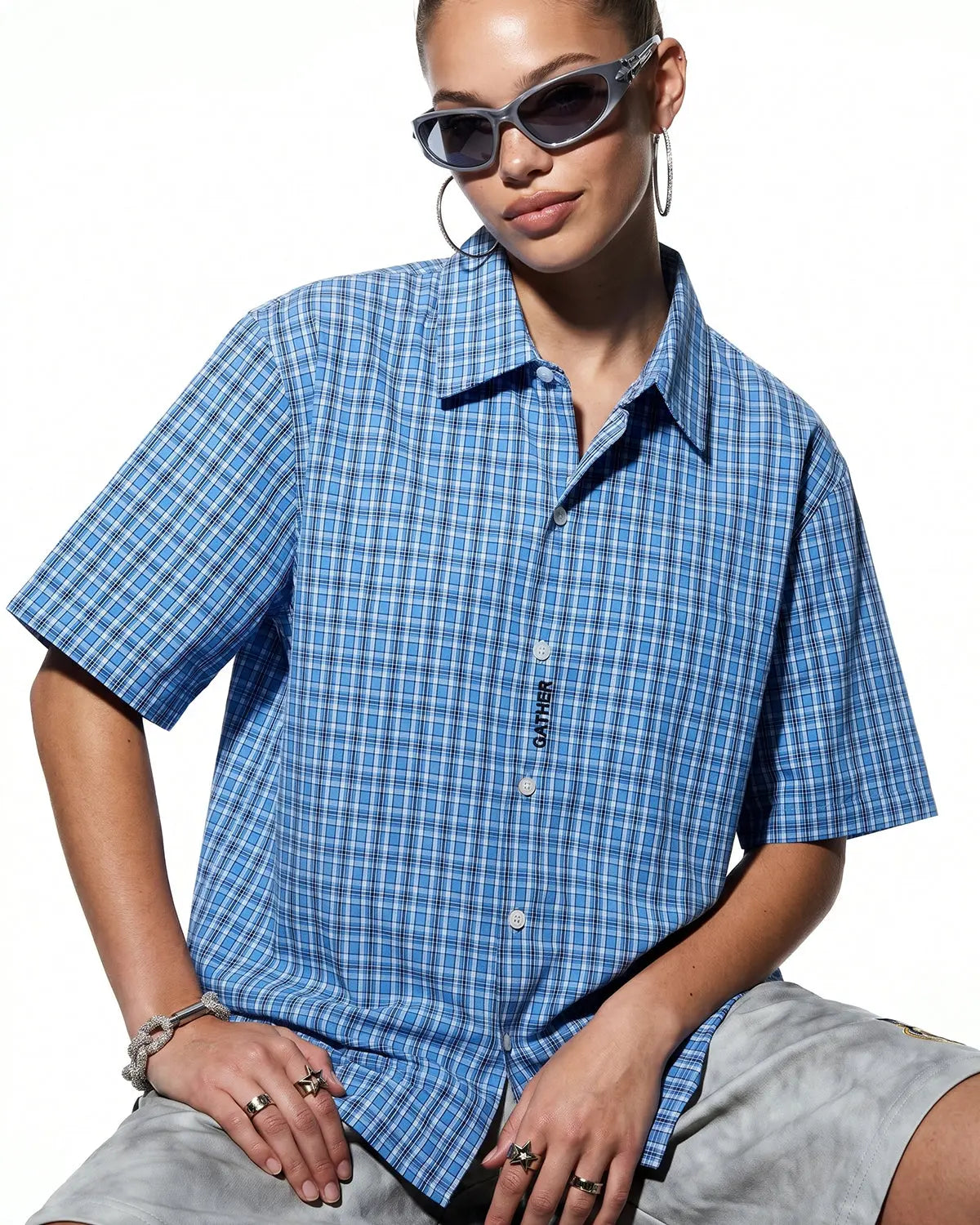 Plaid script embroidered short-sleeve shirt by Flation featuring a casual streetwear design with embroidered logo and plaid pattern.